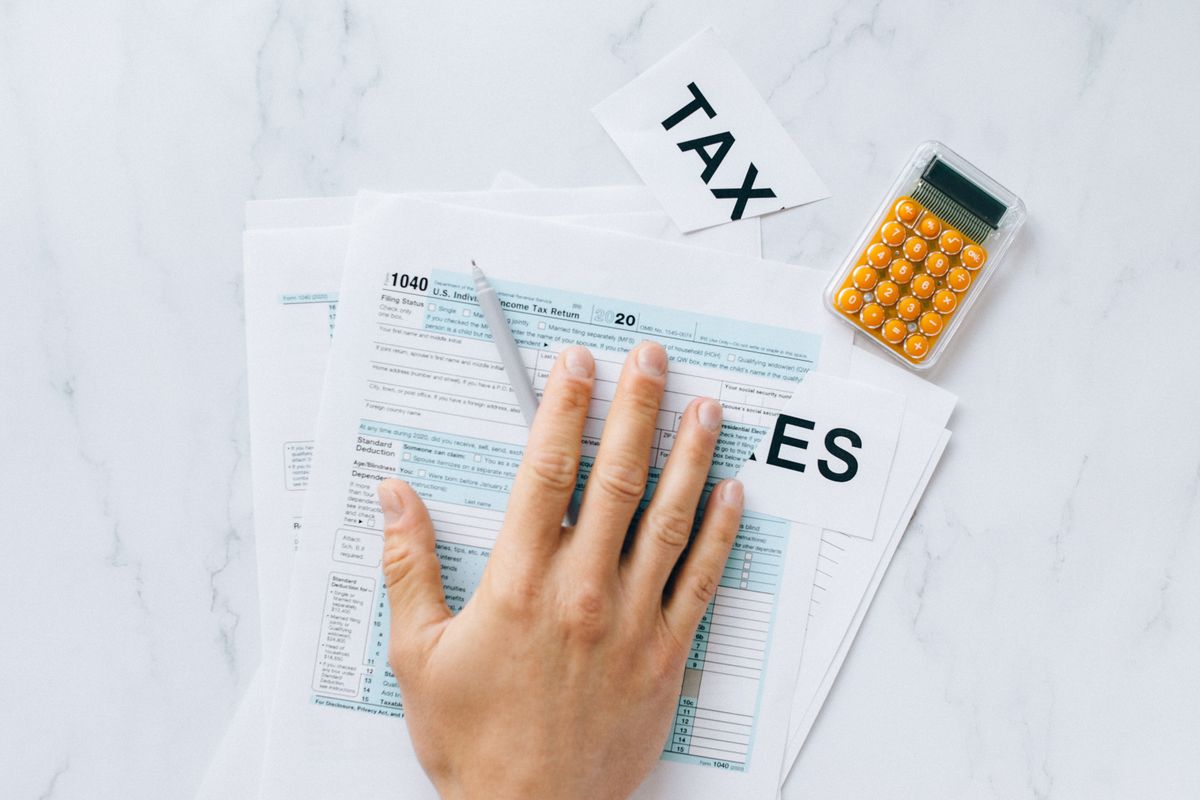 Tax form 1040 with a calculator representing common IRS red flags and filing errors