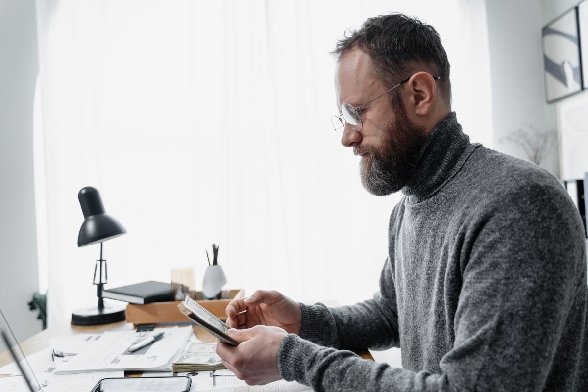 Small business owner reviewing finances and tax paperwork at a desk