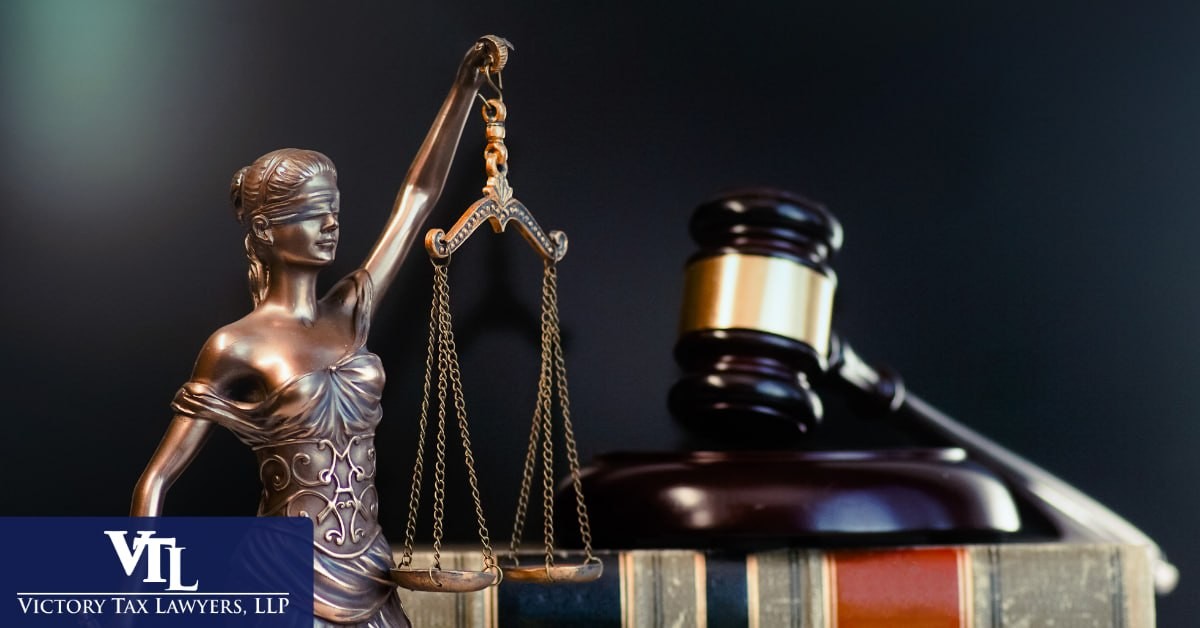A Lady Justice statue and a gavel on law books, representing IRS criminal investigation, Victory Tax Lawyers