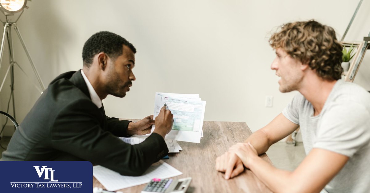 Tax advisor going through audit paperwork with a business owner